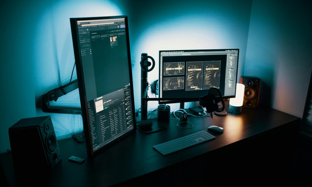 A contemporary office desk featuring a dual monitor setup with stylish lighting, ideal for tech enthusiasts.